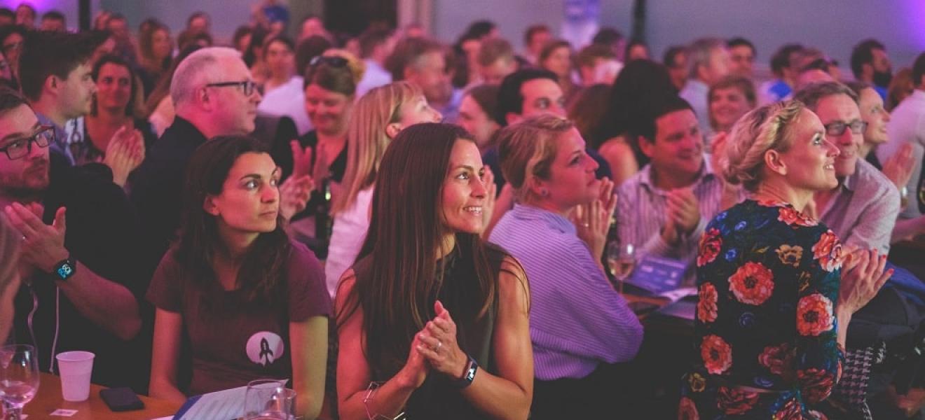 The crowd at a recent Bristol Technology Festival event, clapping and looking at the stage