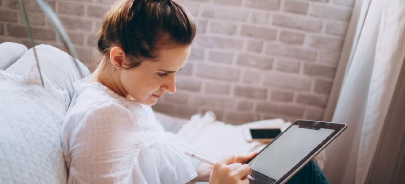 A woman using a tablet at home