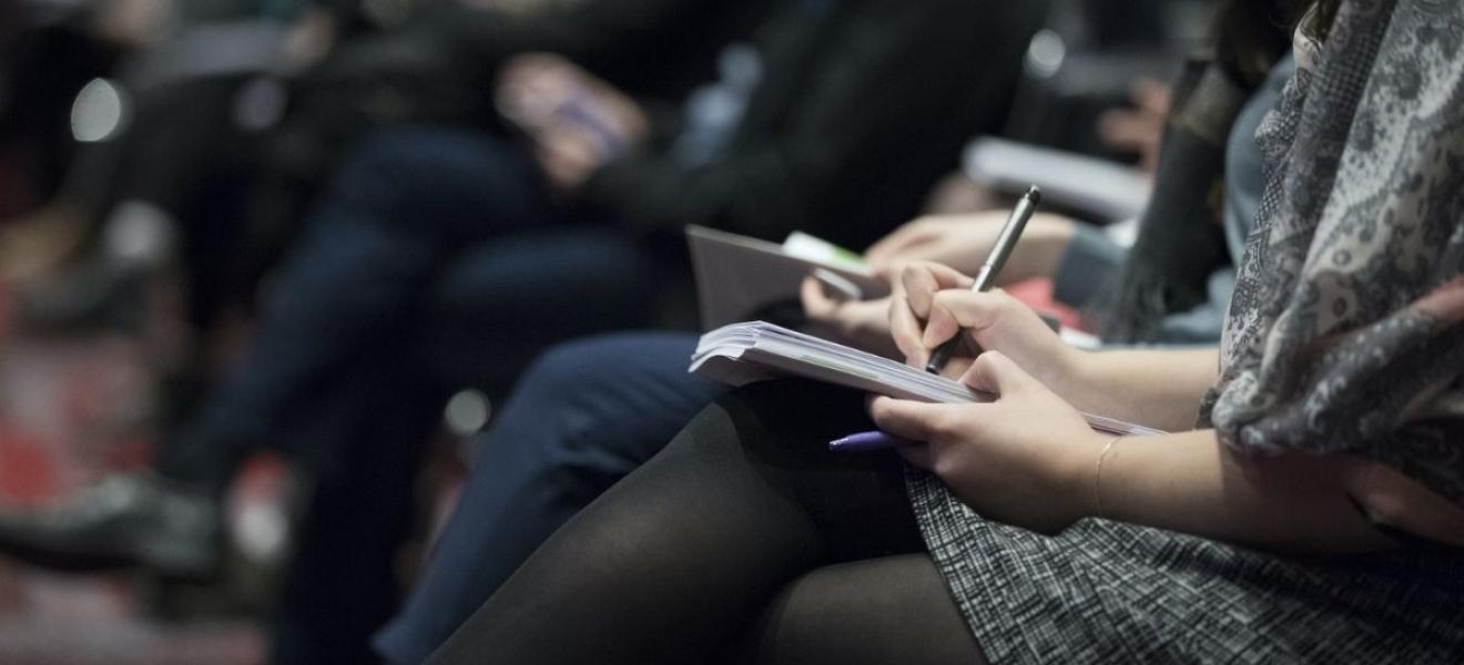 An audience watching a business event