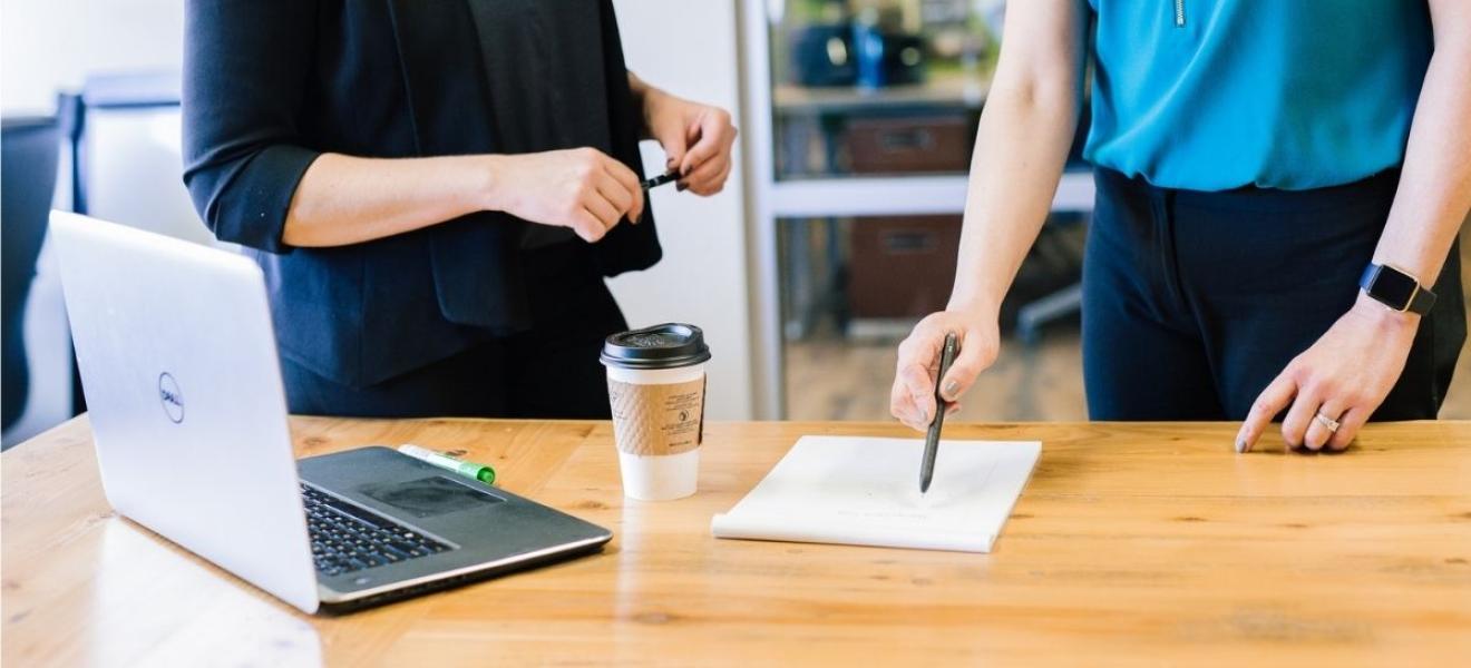 Two people in an office Two people in an office