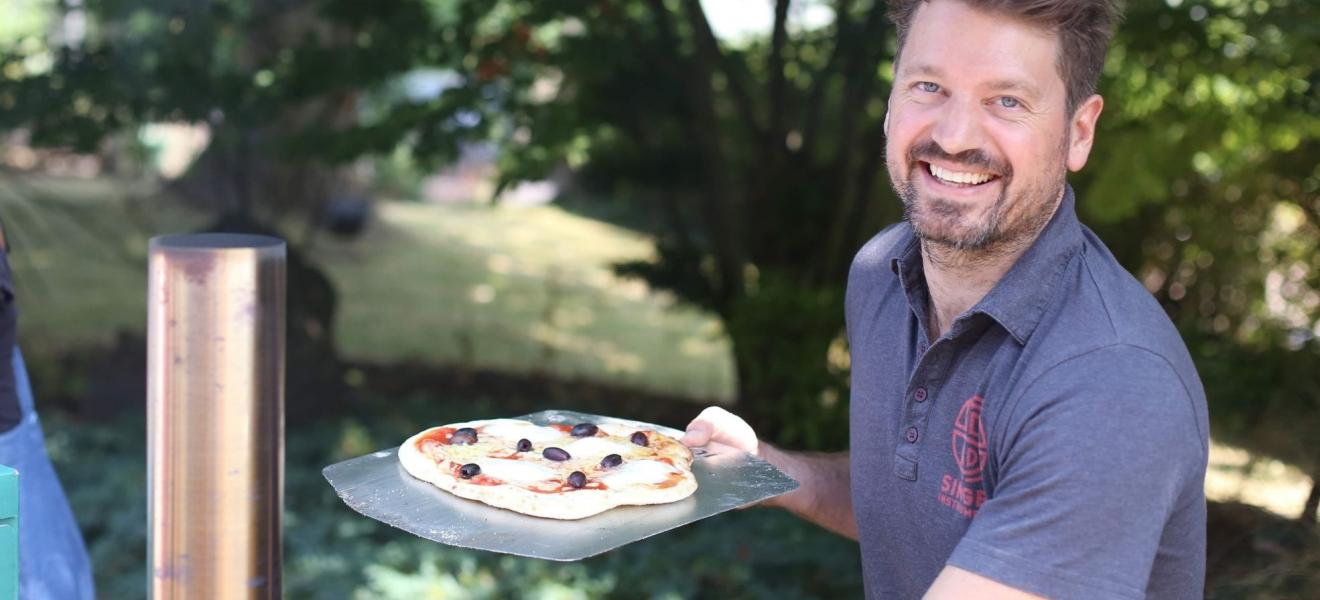 Harry Singer with a pizza