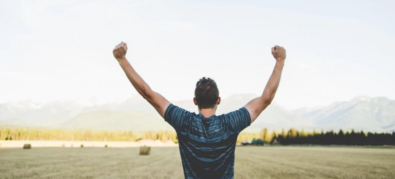 A man celebrating in a field