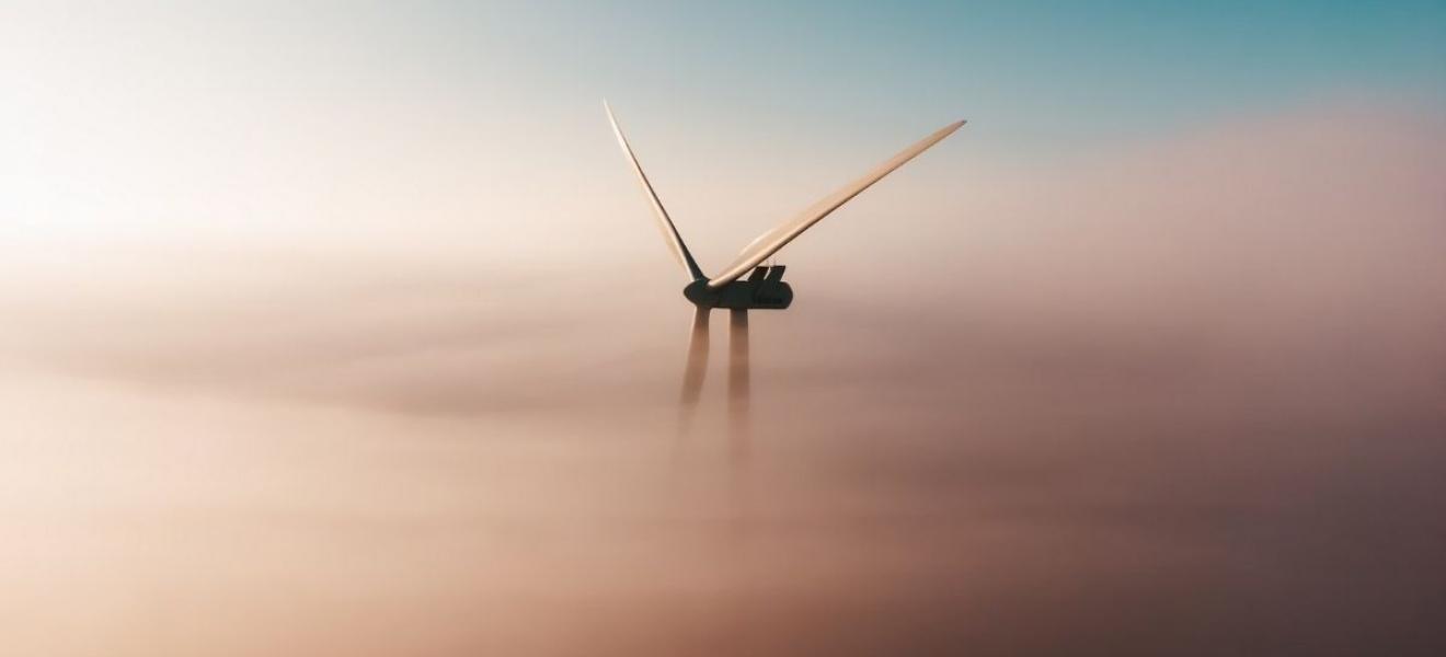 A wind turbine surrounded by clouds
