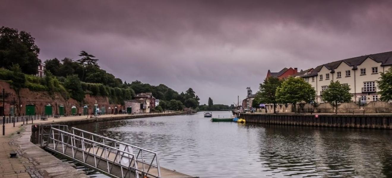 Exeter quay, the river flowing below purple, brooding skies 