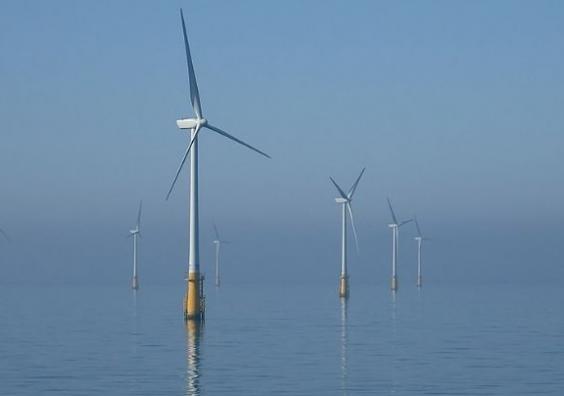 Image: Andy Dingley, edit Muhammad on WikiCommons https://commons.wikimedia.org/wiki/File:Barrow_Offshore_wind_turbines_NR.jpg Wind turbines offshore with a blue sky and calm sea