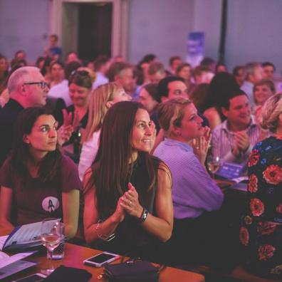 The crowd at a recent Bristol Technology Festival event, clapping and looking at the stage