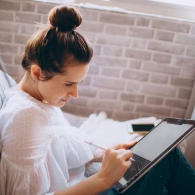 A woman using a tablet at home