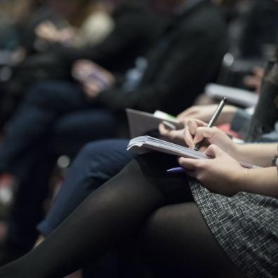 An audience watching a business event