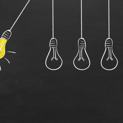 4 unlit lightbulbs hanging static from strings in a row, with a fifth lightbulb glowing