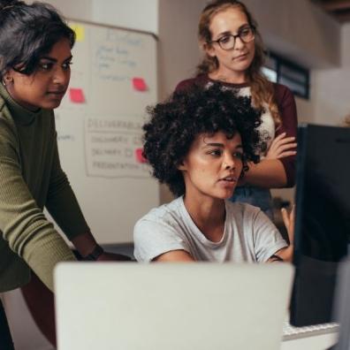 Three professionals using a computer