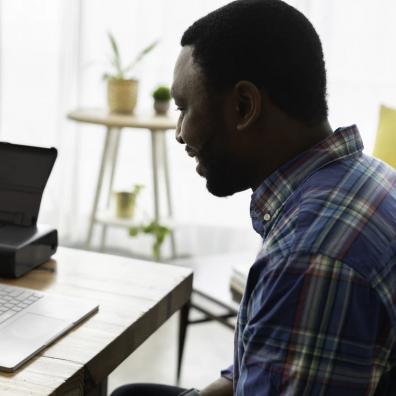 A salesperson working in an office on a virtual call