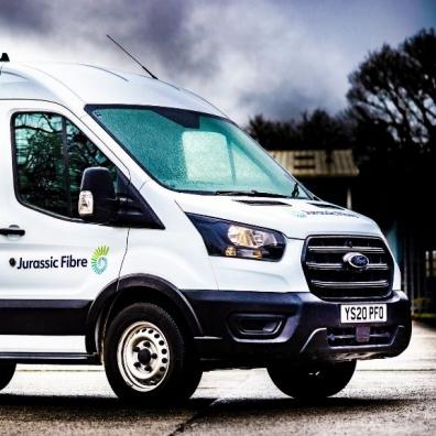 A Ford Transit van branded with Jurassic Fibre livery