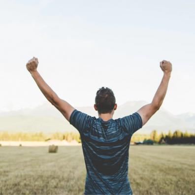 A man celebrating in a field