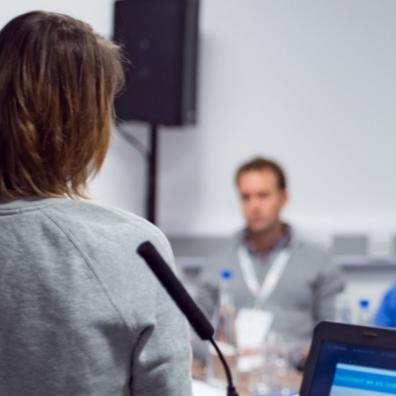 A person pitching to a room of people