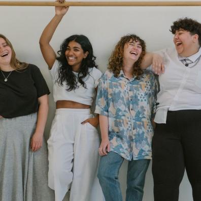 A diverse group of women laughing