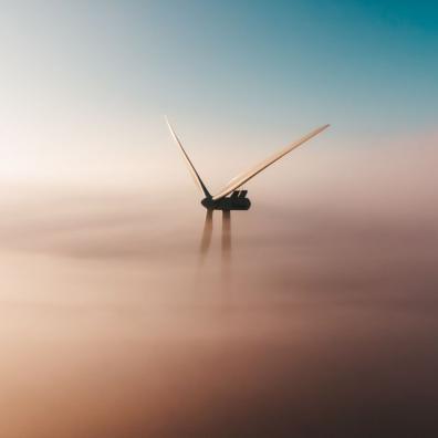 A wind turbine surrounded by clouds