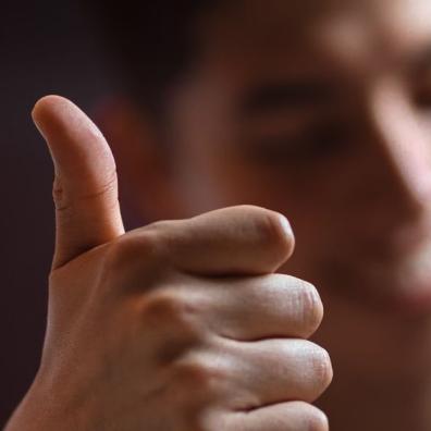 A man doing a 'thumbs up' gesture